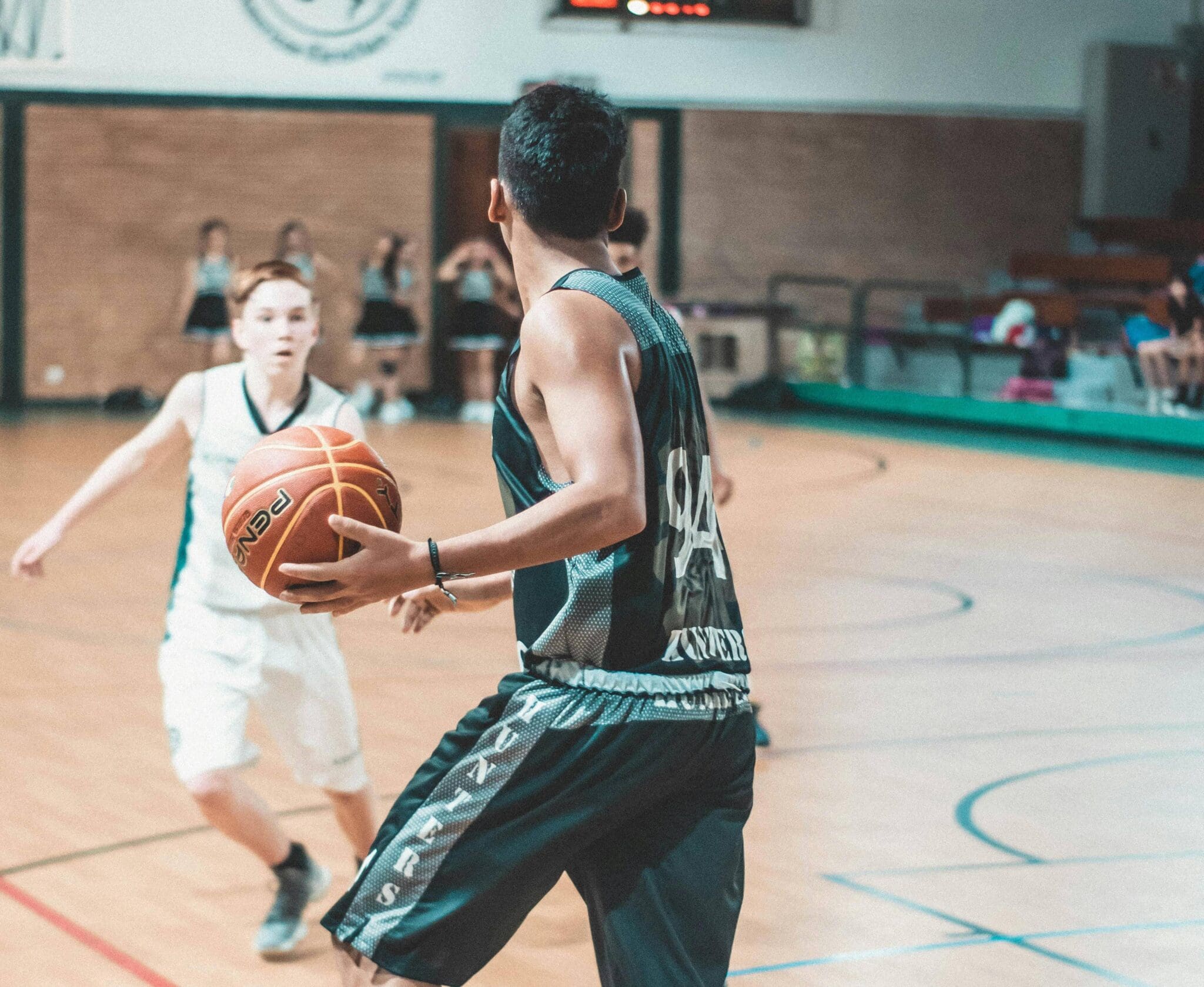 youth basketball game in action, players running plays and positioning